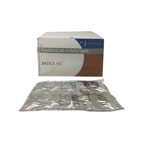 The packaging indicates that these are Doxycycline and Lactic Acid Bacillus Capsules. The box is white with a brown and blue color scheme, prominently displaying the brand name and the manufacturer's logo. The blister pack in the foreground contains individual capsules, with the medication name printed repeatedly across the foil.