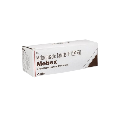 This image shows the pharmaceutical packaging for Mebex, a broad-spectrum anthelmintic medication manufactured by Cipla. The white box identifies the generic formulation as Mebendazole Tablets IP with a dosage strength of 100 mg clearly marked. The brand name, Mebex, is printed in a bold, dark brown font, and the box features a simple design with a brown triangular graphic element on the right side and a red vertical line on the left.