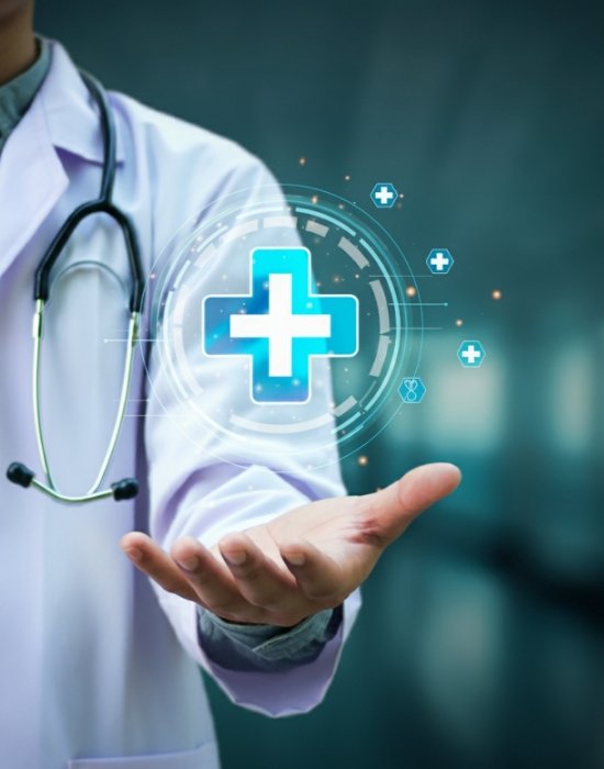 A healthcare professional in a white coat with a stethoscope holding a glowing, holographic medical cross icon.