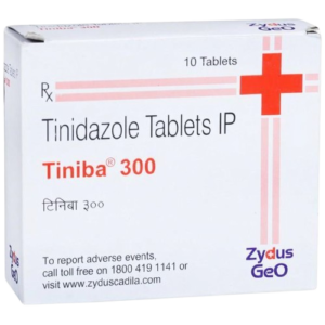 Gemini said An image of a white rectangular medicine box for Tiniba 300. The box features the brand name "Tiniba 300" in a bold red font, with the generic name "Tinidazole Tablets IP" printed above it in black. A large red plus sign is positioned in the upper right corner, with two thin red lines extending vertically and horizontally from it. The box also displays the manufacturer's logo, "Zydus GeO," in the bottom right corner, and specifies that it contains 10 tablets. Additional text at the bottom provides contact information for reporting adverse events.