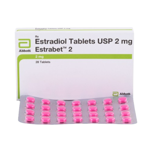 A product shot featuring a white and green box of Estrabet 2 standing behind a silver blister pack of 28 bright pink round tablets. The box prominently displays the Abbott logo and identifies the medicine as Estradiol Tablets USP 2 mg. The design includes a lime green stripe across the middle and specifies the quantity as 28 tablets.
