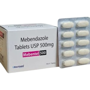 This image showcases the box and blister pack for Mebentel 500, an anthelmintic medication manufactured by Kachhela. The box displays the generic name as Mebendazole Tablets USP 500mg in bold black lettering, with the brand name highlighted in a pink and black rectangular tag. The white packaging indicates a "10x10 Tablets" quantity. Standing next to the box is a silver blister strip containing ten large, oval-shaped white tablets arranged in two columns.